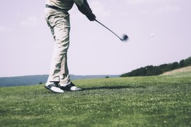 man swinging golf stick
