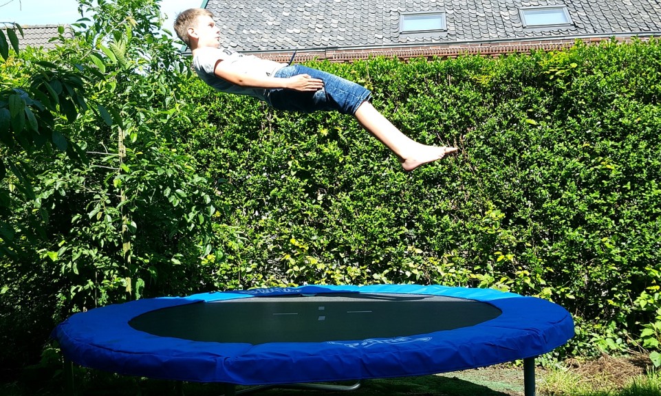 boy jumping on trampoline