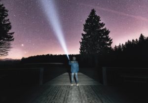 man playing flshlight