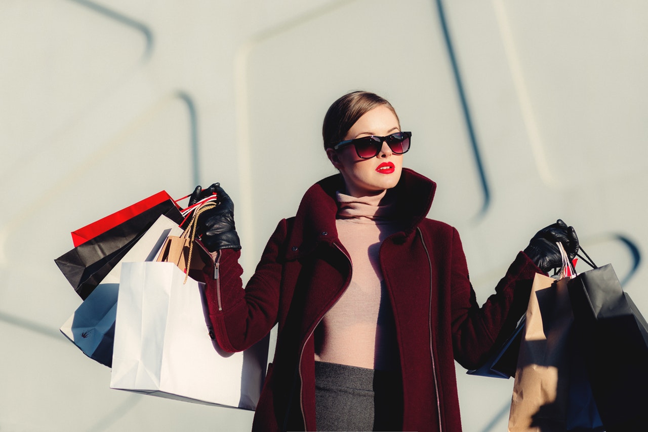 a woman holding some clothes bags